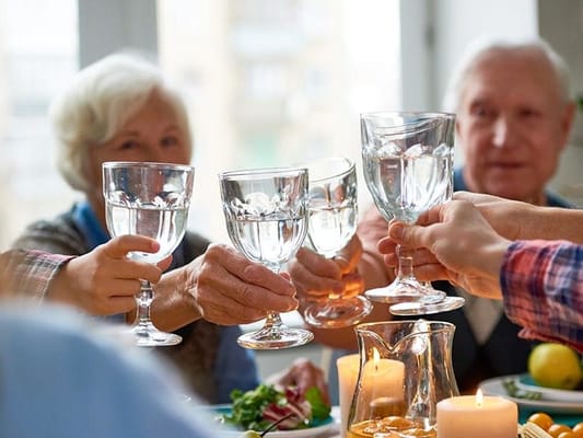 Residents toasting with glasses at a gathering