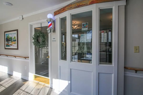 Interior view of a common area with barber station and decorations