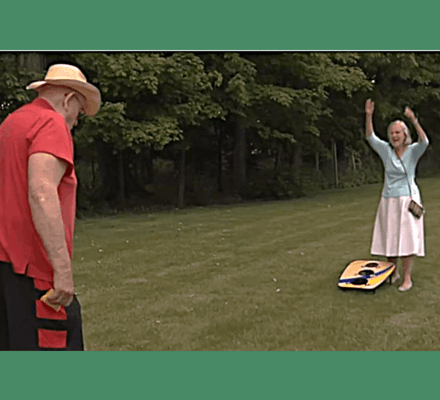 Residents enjoying outdoor activities in a sunny garden