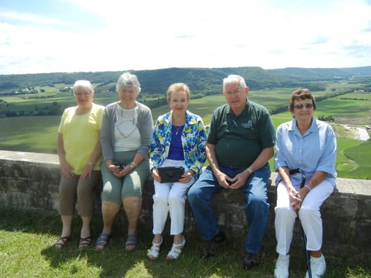 Five seniors enjoying a scenic outdoor view