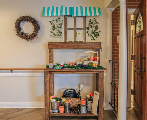 Decorative indoor display with flowers and tools