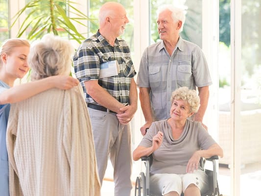 Residents and staff interacting in a bright common area