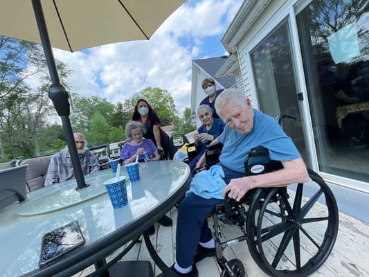 Residents enjoying time together outdoors on a patio