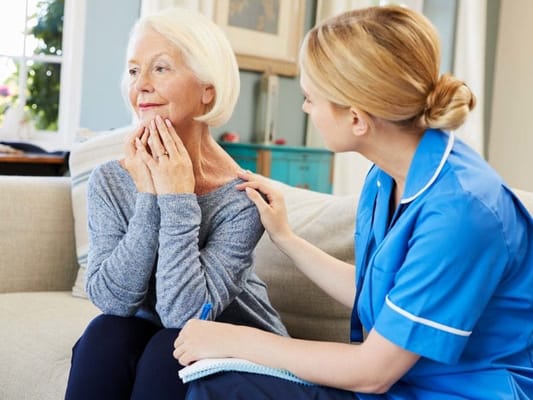 Caregiver consulting with a resident in a cozy living room