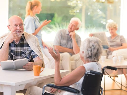 Residents engaging in conversation in a bright common area