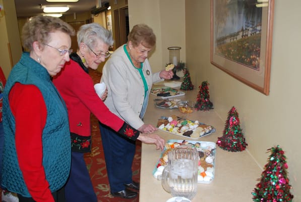 Residents enjoying a dessert buffet in a common area