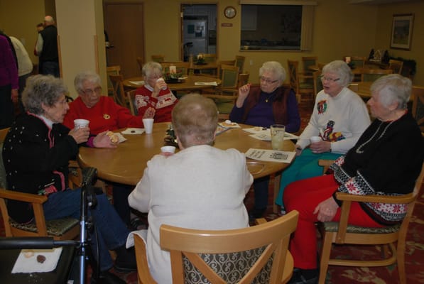 Residents socializing around a table in a common area