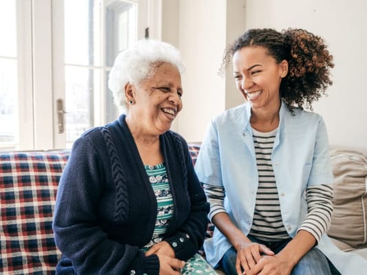 Smiling caregiver and resident enjoying time together