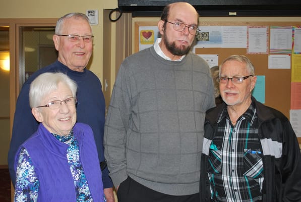 Group of residents smiling in an indoor common area