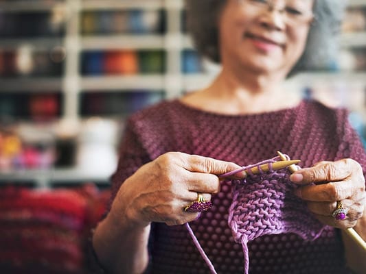 Resident engaging in knitting activity