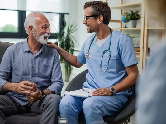 Resident and caregiver smiling during conversation