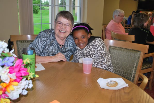 Resident and child enjoying a cheerful moment together