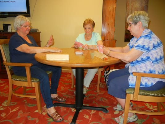 Residents engaging in a card game in a common area