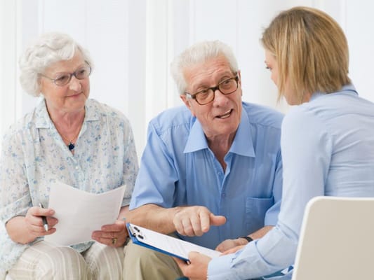 Residents discussing with staff in a common area
