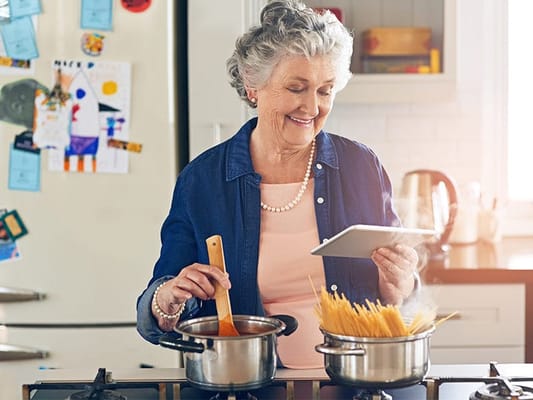 A senior woman cooking in a kitchen