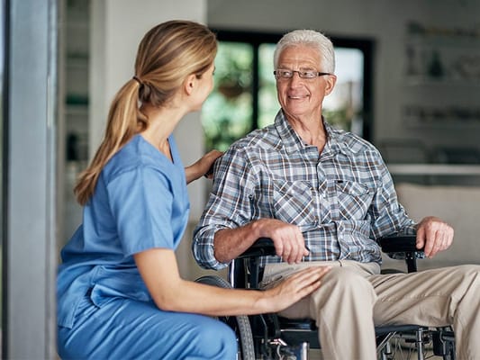 Staff member interacting with a resident in a cozy setting