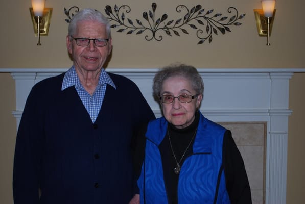 Two residents posing in a cozy indoor setting