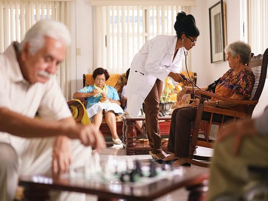 Medical staff attending to residents in a common area