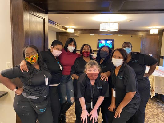 Staff members posing together in a common area