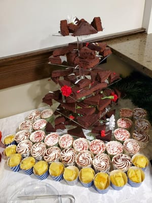 A display of assorted desserts and treats on a tiered stand.
