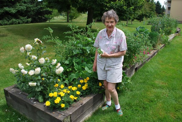 Resident tending to a garden with flowers