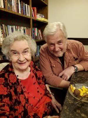 Resident and staff member smiling together