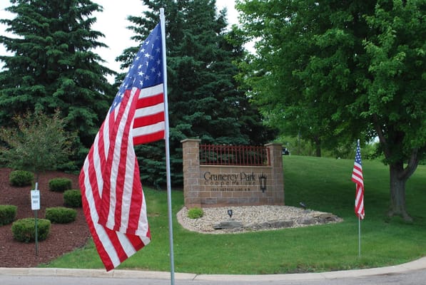 Entrance sign for Gramercy Park Cooperative with flags