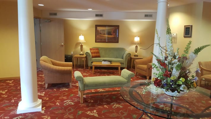 Cozy common area with seating and floral arrangement