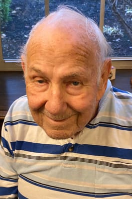 An elderly man smiling for the camera