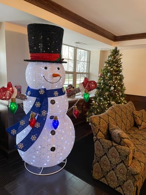 Decorative snowman and Christmas tree in a lobby area