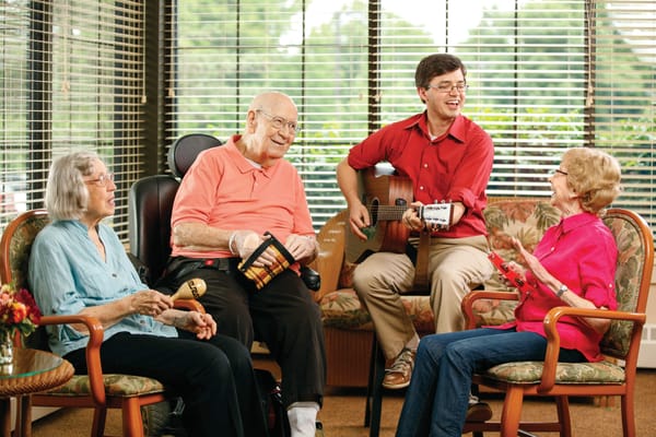 Residents enjoying a music activity in a common area