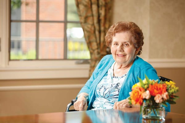 A smiling senior woman in a well-lit interior