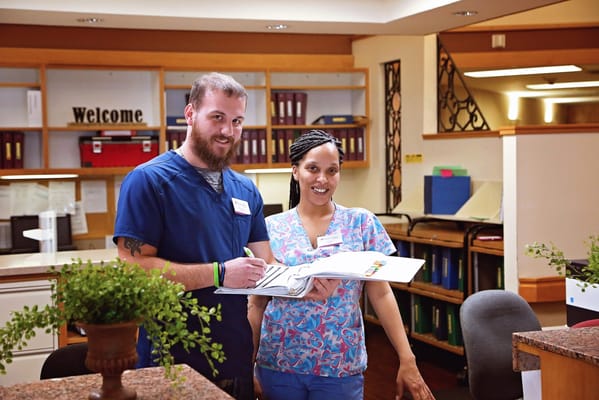 Staff members engaging in a conversation at the reception area