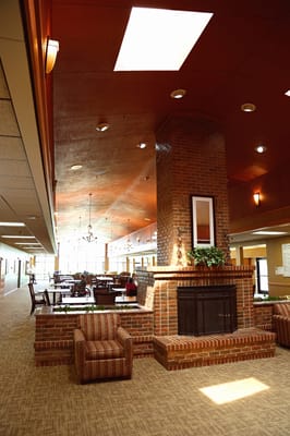 Bright, spacious common area with seating and fireplace
