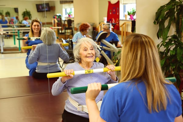 Residents participating in exercise therapy with staff supervision