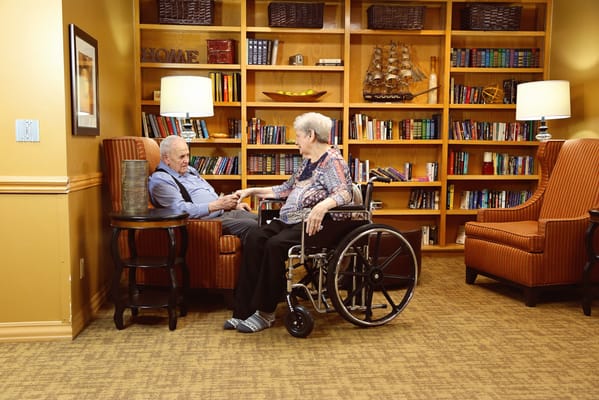 Residents interacting in a cozy library area