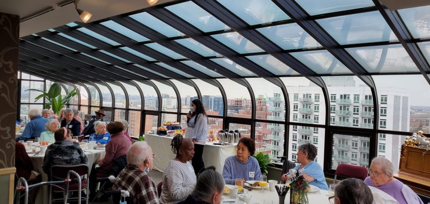 Residents enjoying a meal in a bright dining area