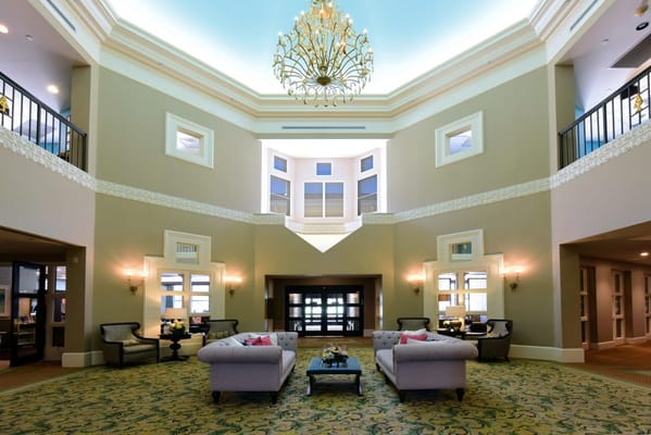 Elegant lobby area with chandeliers and seating