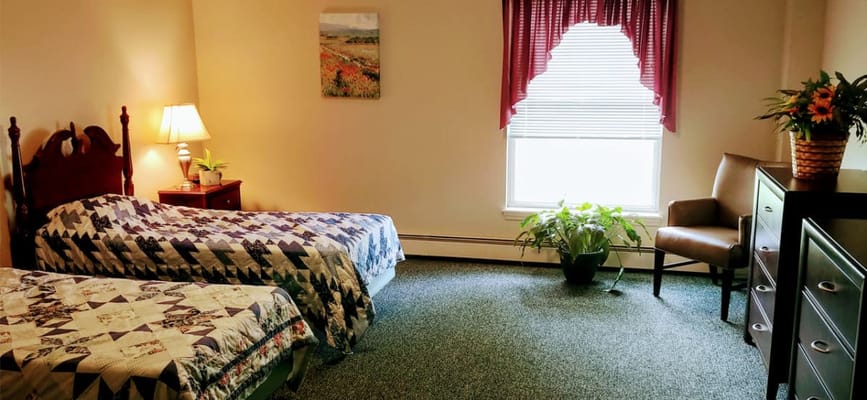 Cozy room with two beds and a chair