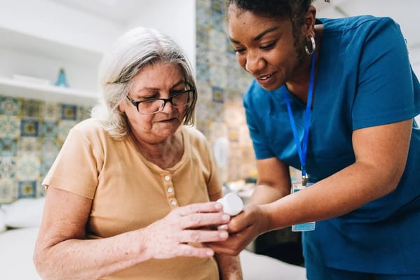 Nurse assisting a resident with medication