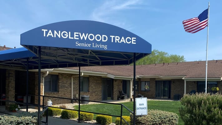 Main entrance of Tanglewood Trace with American flag