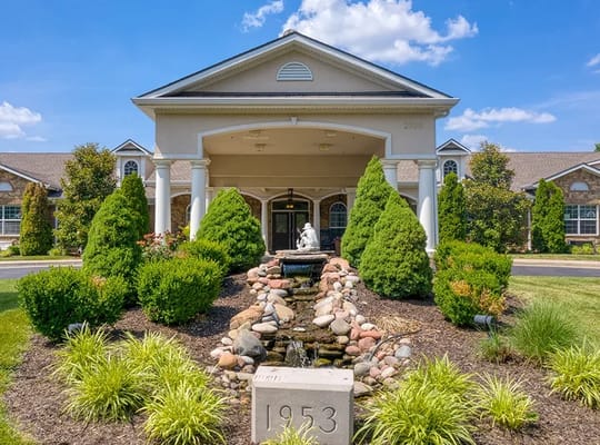 Front entrance with landscaped garden and fountain