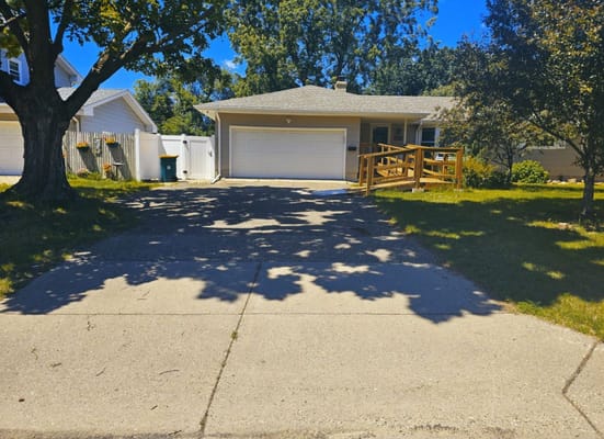 Exterior view of a facility with a driveway and greenery