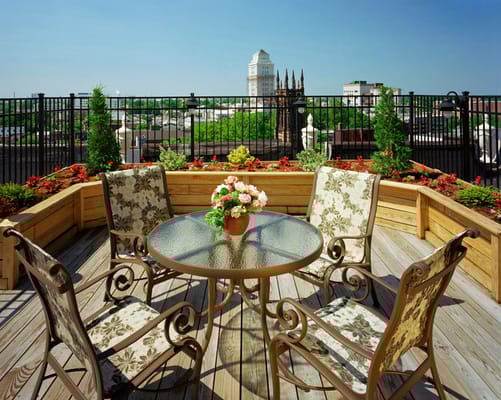 Outdoor seating area with flowers and city view