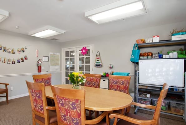 Bright activity room with a round table and decorations