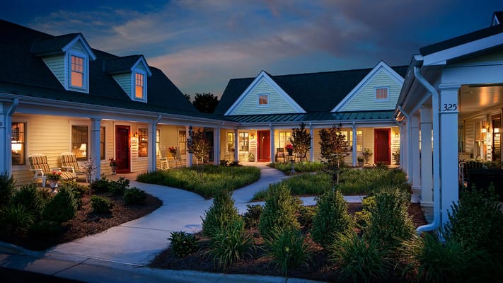 Welcoming exterior view of a senior living facility at dusk