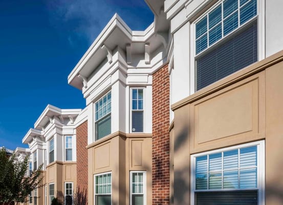 Exterior view of a senior living building with blue sky