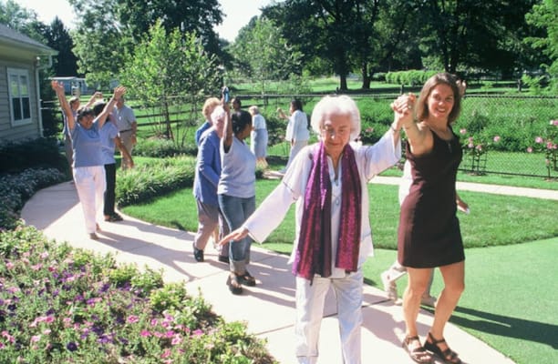 Residents and staff enjoying a walk in the garden