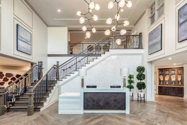 Elegant interior lobby with a staircase and reception desk