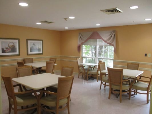 Common area with tables and chairs in a dining hall